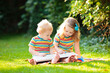 © famveldman - Kids play outdoor in sunny summer garden