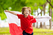 © famveldman - Child running with Poland flag. Little Polish fan