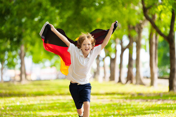 Wall Mural - Child running with Germany flag.