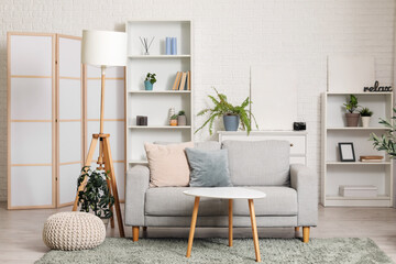 Wall Mural - Interior of stylish living room with folding screen, grey sofa, shelving unit and coffee table