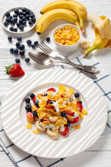 Wall Mural - fresh berries, banana with corn flakes and yogurt