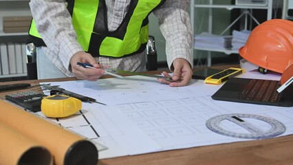 Wall Mural - business man hand working and laptop with on on architectural project at construction site at desk