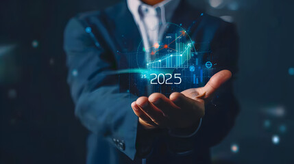 Wall Mural - Businessman holding a virtual hologram icon of a growth graph and arrow up with the text 2025 