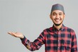 © typepng - A young Asian Muslim man embraces you, welcoming you with a toothy smile and sharing love with you against a white background. People religious Islamic lifestyle concept.