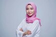 © typepng - Young Asian Muslim woman standing with crossed arms and looking confident isolated over white background