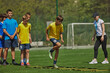 © master1305 - Dynamic Soccer Drill. Young soccer players, boys in uniform training outdoors with coach, doing exercises with agility ladder. Concept of sport, school, childhood, hobby, active lifestyle