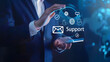 © Oleksandr - Businessman touching virtual screen with text Support and icons of obedient. mail. phone. on dark blue background