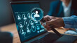 © Oleksandr - Businessman using a magnifying glass to choose a horizon people icon on a laptop screen for selecting human resources or customer service