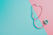 © HecoPhoto - Pink stethoscope on blue and pink background Medical concept