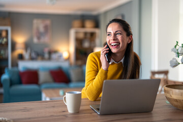 Wall Mural - Happy smiling woman having fun conversation over mobile phone, hearing good news. Woman talking over cellphone in a home office.