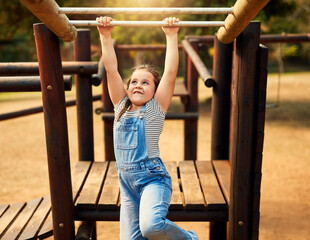 Girl, hanging and monkey bars play outdoors playground, climbing or games with exercise of motor development. Kid, adventure and fun on jungle gym park, balance or energy for physical growth