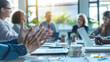 © Oleksandr - Closeup of hands raised in conversation during an office meeting. with laptops and notepads on the table