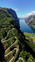 Wall Mural - Drone top view Aerial view of the curved road to Lysebotn in Norway, Lysefjord on a beautiful summer day with a blue sky