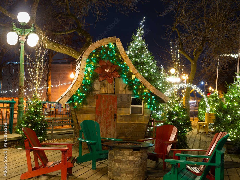 Festive seating area and tiny wooden cabin decorated for Christmas in ...