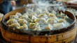 © vetrana - Steaming process of chinese dumplings on bamboo tray in traditional cooking method