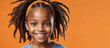 © mischenko - Black girl with dreadlocks on an orange background