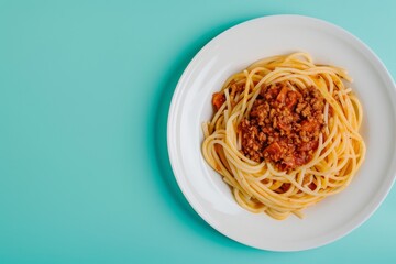 Wall Mural - A Single Serving of Spaghetti With Meat Sauce on a White Plate Against a Turquoise Background