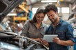 © spyrakot - Service Advisor and Customer Reviewing Diagnostic Results on Digital Tablet in Auto Repair Shop