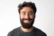 © Serhii - Front Face Man. Young Hispanic Man with Beard Smiling Happily in Casual Attire
