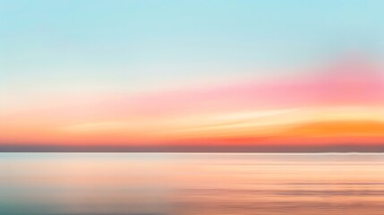 Amazing colorful sunset over calm water. The sky is ablaze with vibrant oranges, pinks, and purples, reflecting off the still water below.