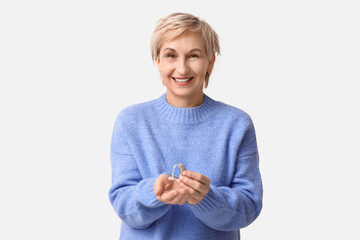 Poster - Mature woman with hearing aid on white background