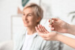 © Pixel-Shot - Female hands with hearing aid in room