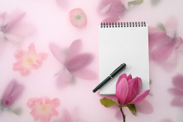 Wall Mural - Guest list. Notebook, pen and magnolia on spring floral background, flat lay. Space for text