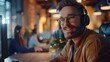 © horizon - A professional call center agent is wearing headphones and sitting at his desk, engaging in an online conversation with the customer using modern technology.