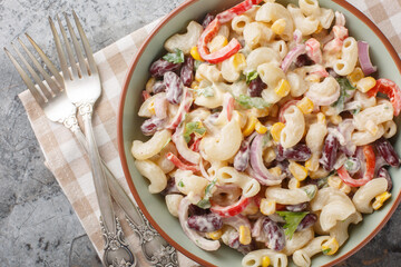 Wall Mural - Homemade Southwestern elbow pasta salad with fresh vegetables and creamy dressing close up on the bowl on the table. Horizontal top view from above