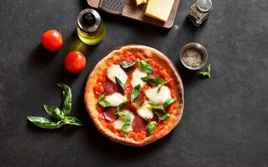 Wall Mural - Pizza with mozzarella, pepperoni, tomato sauce and basil