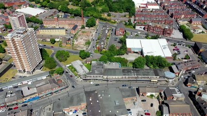 Wall Mural - Aerial drone footage of the town centre of Armley in Leeds West Yorkshire on a bright sunny summers day showing apartment blocks and main road going in to the town centre