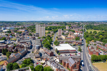 Canvas Print - Aerial photo of the town centre of Armley in Leeds West Yorkshire on a bright sunny summers day showing apartment flats block building with the main road leading up to the main street in the village
