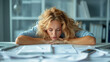 © suyu - Exhausted businesswoman in a shirt sitting at an office desk, representing workplace fatigue and perseverance