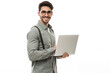 © Oksana - Portrait of young modern businessman standing holding laptop isolated on white background