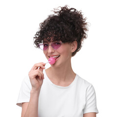 Wall Mural - Beautiful woman in sunglasses with lollipop on white background
