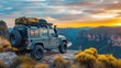 © Shadowkiruu - A jeep is parked on a mountain top with a sunset in the background