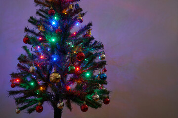 Detail of a Christmas tree with lights on isolated white background.