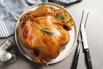 Canvas Print - Tasty roasted chicken with rosemary and lemon served on light grey table, flat lay