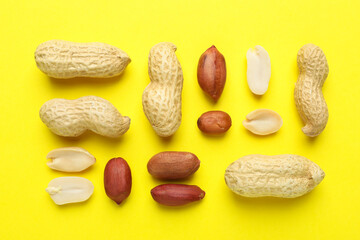 Wall Mural - Fresh peanuts on yellow background, flat lay