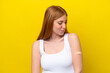 © luismolinero - Young redhead woman wearing a band-aids isolated on yellow background with sad expression