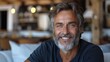 © Pixel Mind - Smiling Middle-Aged Man Sitting Indoors