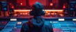© Starkreal - A sound technician focused on audio mixing in a contemporary recording studio, stylish outfit and large headphones, seen from behind