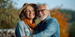 © Iryna - Happy senior couple embracing outdoors in nature, enjoying leisurely walk together, radiating love and joy