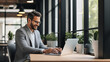 © Наталья Сивак - Smiling Businessman Working on Laptop in Modern Office