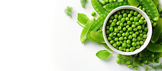 Top view of fresh organic raw green peas in a bowl surrounded by pea pods and plant leaves This healthy vegan and vegetarian legume food is rich in bean protein making it an excellent choice for raw