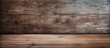 © StockKing - A worn and rustic wooden table with a textured surface perfect for use as a background or for displaying objects copy space image