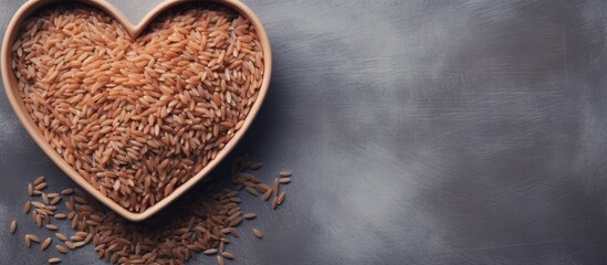 Aufkleber - Brown rice in heart shaped bowl on gray cement background Copy space Top view or flat lay