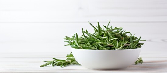 Poster - Bowl of dry tarragon on white wooden table Space for text. copy space available