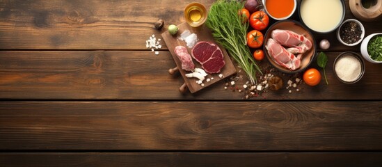 Poster - Flat lay composition with oil pot meat fondue ingredients and space for text on wooden background. copy space available