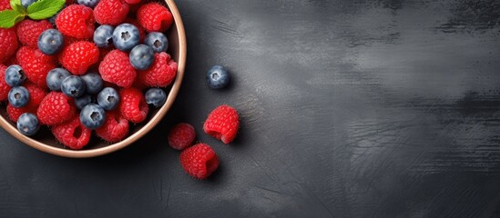 Poster - Bowl of fresh raspberry and blueberry top view with copy space